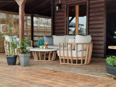 a patio with a couch and chairs and a table at NuA House 