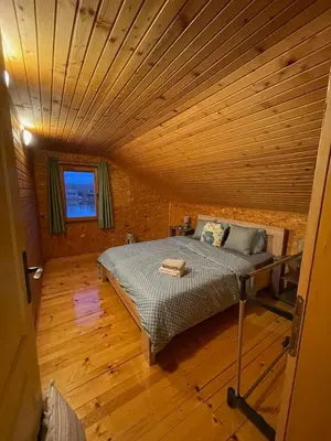 a bed in a room with a wooden ceiling at NuA House 