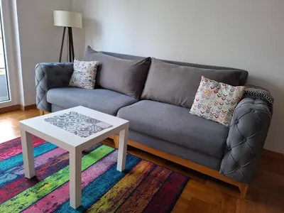 a living room with a couch and a coffee table at Dina's Place in Podgorica