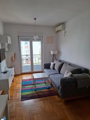 a living room with a couch and a table at Dina's Place in Podgorica