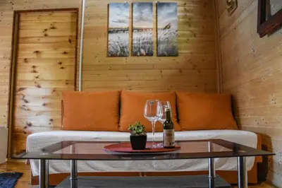 a living room with a couch and a table with wine glasses at Jungle 1 House Ada Bojana in Ulcinj