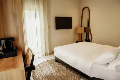 a bedroom with a white bed and a television at Hotel 1920 in Podgorica