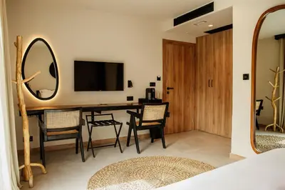 a living room with a table and chairs and a television at Hotel 1920 in Podgorica