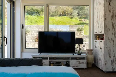 a living room with a flat screen tv on a table at Majestic Apartment in Tivat