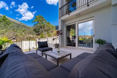 a living room with a couch and a table at Majestic Apartment in Tivat