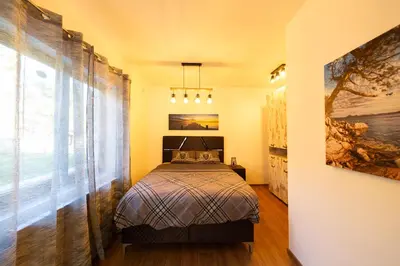 a bedroom with a bed and a large window at Majestic Apartment in Tivat
