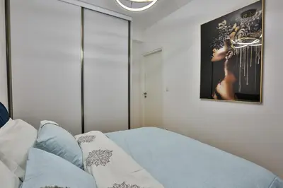 a bedroom with a bed and a picture on the wall at Apartments Centar Montesun in Budva