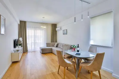 a living room with a table and a couch at Apartments Centar Montesun in Budva