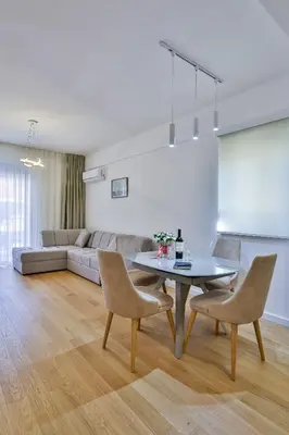 a living room with a table and chairs and a couch at Apartments Centar Montesun in Budva