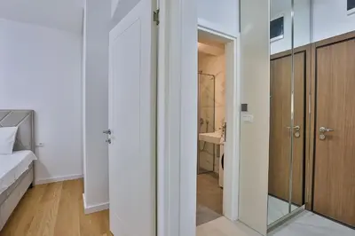 a bedroom with a bed and a glass door at Apartments Centar Montesun in Budva