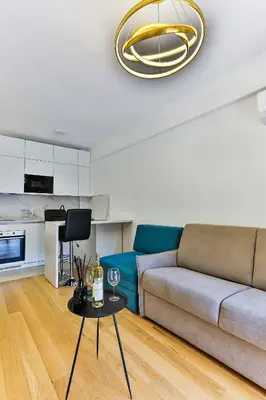 a living room with a couch and a table with wine glasses at Apartments Centar Montesun in Budva