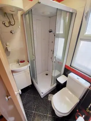 a bathroom with a shower and a toilet and a sink at Studio apartment CENTER in Podgorica