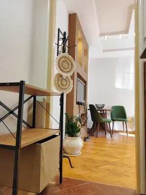 a living room with a shelf and a table at Studio apartment CENTER in Podgorica