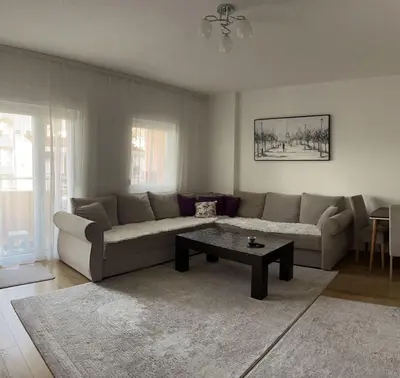 a living room with a couch and a coffee table at Lina Apartment in Bar