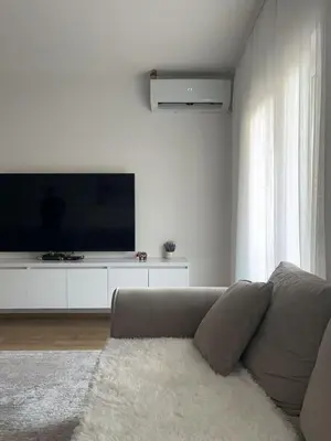 a living room with a couch and a flat screen tv at Lina Apartment in Bar