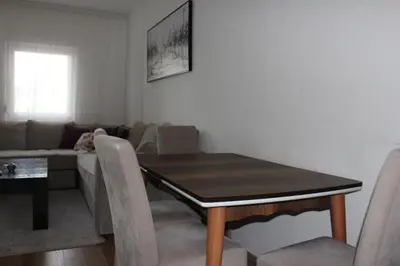 a living room with a table and a couch at Lina Apartment in Bar