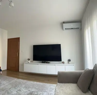 a living room with a flat screen tv on a wall at Lina Apartment in Bar