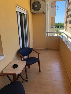 a room with two chairs and a table and a balcony at Lina Apartment in Bar