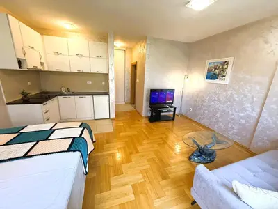 a living room with a bed and a kitchen at Renta Stanovi Podgorica in Podgorica