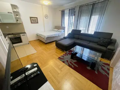 a living room with a couch and a table at Renta Stanovi Podgorica in Podgorica