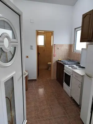 a small kitchen with a stove and a sink at Apartments Kalamperovic in Bar