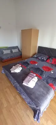 a bedroom with two beds and a box at Apartments Kalamperovic in Bar