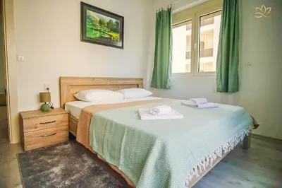 a bedroom with two beds with towels on them at Apartment Lotus in Ulcinj