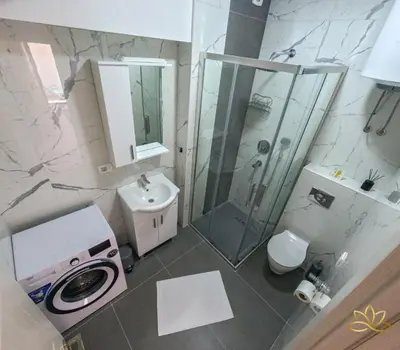 a bathroom with a shower and a toilet and a sink at Apartment Lotus in Ulcinj