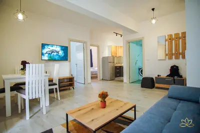 a living room with a blue couch and a table at Apartment Lotus in Ulcinj