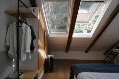 a attic bedroom with a bed and a window at Nest 382 in Kotor