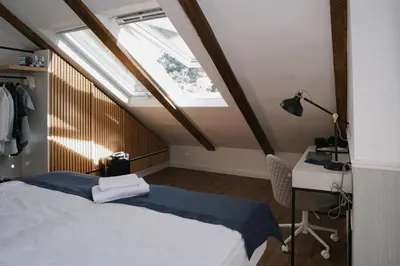 a bedroom with a bed and a desk and a window at Nest 382 in Kotor
