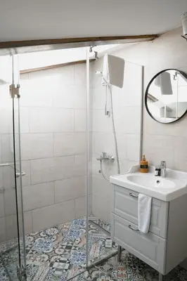 a bathroom with a sink and a shower at Nest 382 in Kotor