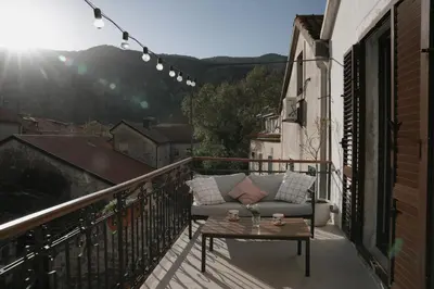 a couch sitting on a balcony with a table at Nest 382 in Kotor