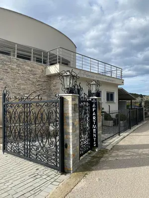 a gate in front of a house with a building at PRINCESS - Valdanos in Ulcinj