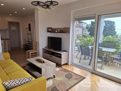 a living room with a couch and a tv at Rudovic Apartments in Ulcinj