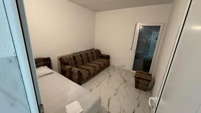 a living room with a couch and a chair at Sabo Villa in Pečurice