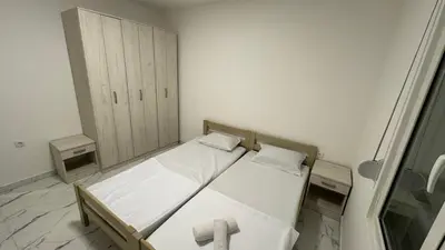 a small bedroom with two beds and a cabinet at Sabo Villa in Pečurice