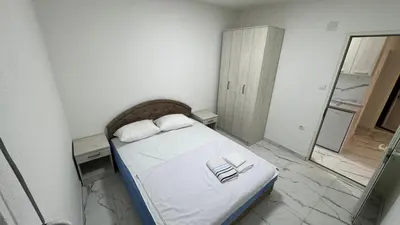 a bedroom with a bed with two books on it at Sabo Villa in Pečurice