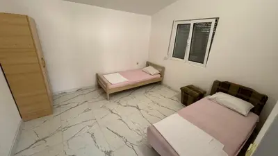 a small room with two beds and a window at Sabo Villa in Pečurice