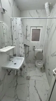a white bathroom with a sink and a toilet at Sabo Villa in Pečurice