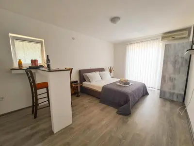 a bedroom with a bed and a table with a chair at Lemon&Olives in Budva