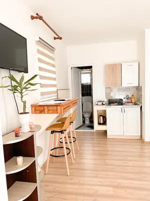 a kitchen with white cabinets and a table and chairs at Lemon&Olives in Budva