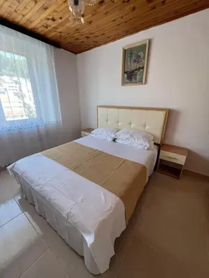 a bedroom with a large bed and a window at City Heart Apartments 2 in Ulcinj