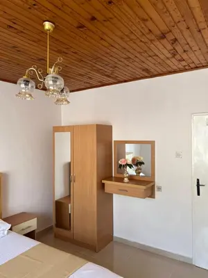 a bedroom with a bed and a wooden ceiling at City Heart Apartments 2 in Ulcinj