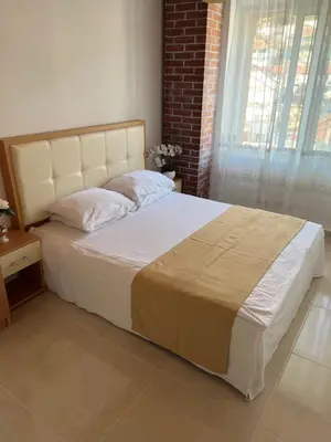 a large bed in a bedroom with a window at City Heart Apartments 2 in Ulcinj