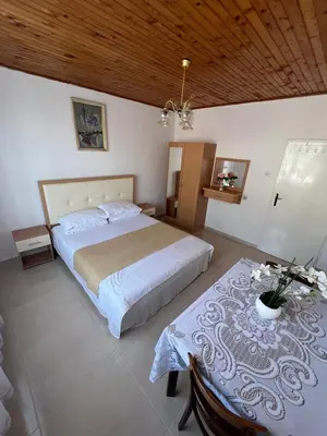 a bedroom with a large bed and a table at City Heart Apartments 2 in Ulcinj