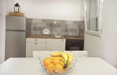 a bowl of fruit on a table in a kitchen at Casa Calda apartman in Budva