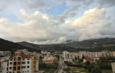 a view of a city with buildings and clouds at Casa Calda apartman in Budva
