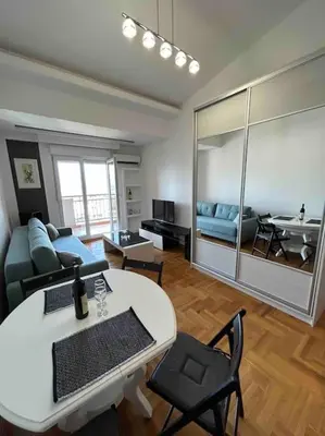 a living room with a couch and a table at Stylish_apartment in Podgorica