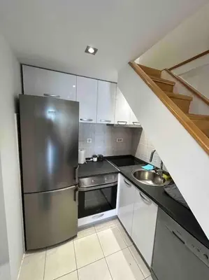 a kitchen with a stainless steel refrigerator and a sink at Stylish_apartment in Podgorica